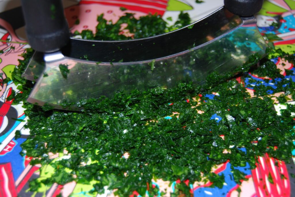 cutting wild garlic finely with herb knife