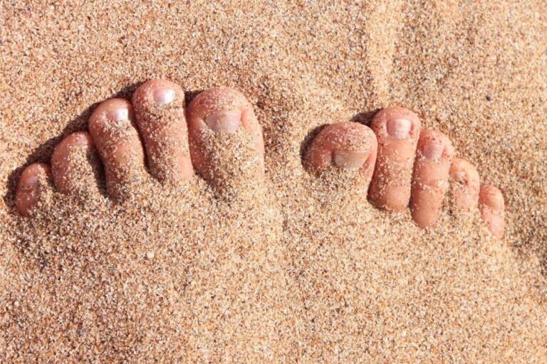 Natural healthy toe nails in the sand.