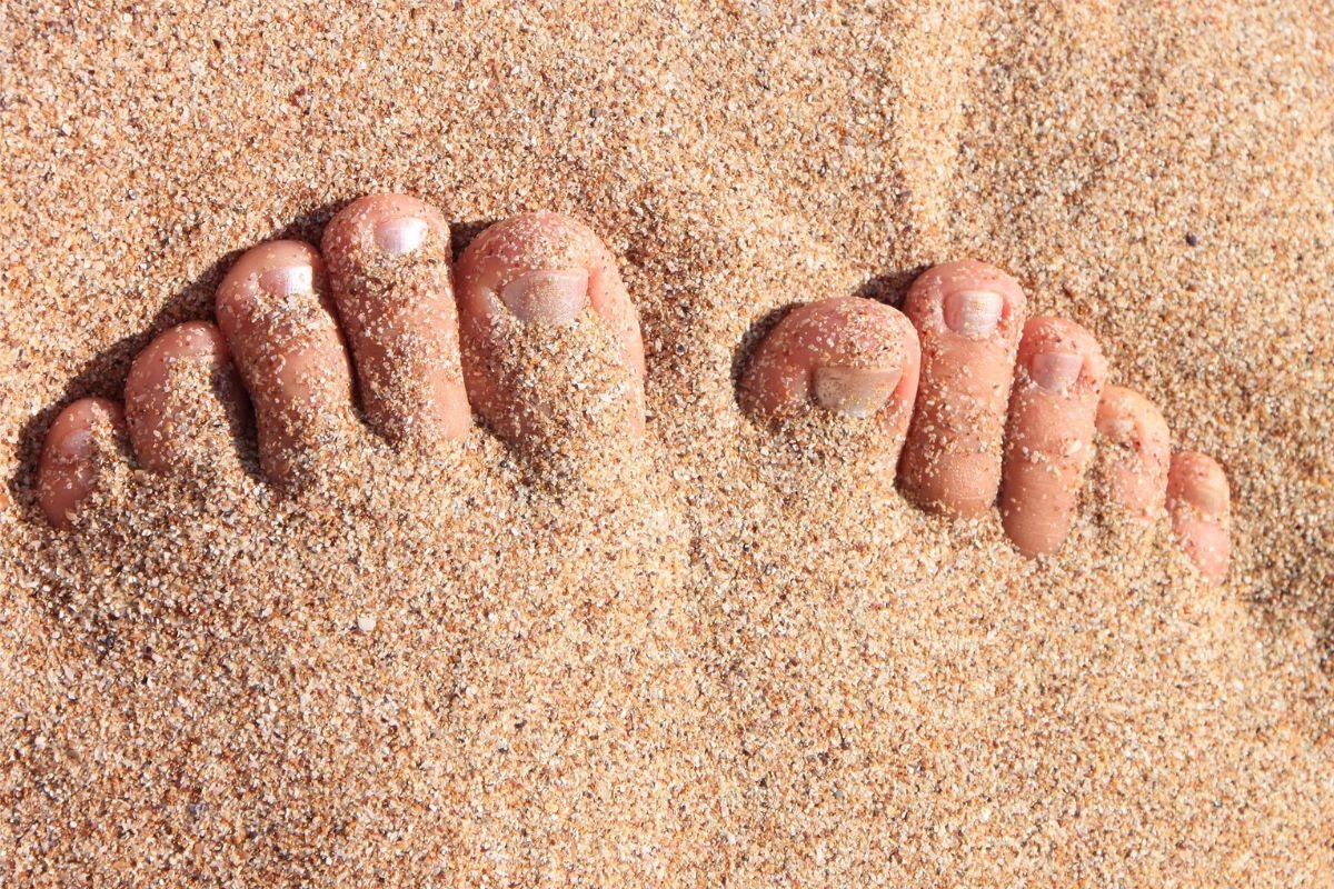 Natural healthy toe nails in the sand.